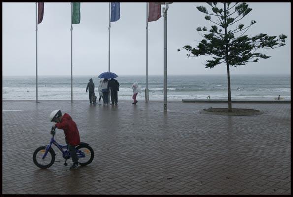people still enjoy time out at Manly beach, even though it's raining and cold 