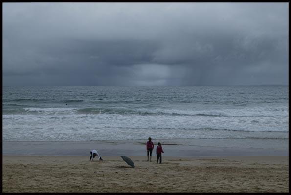 people still enjoy time out at Manly beach, even though it's cold and wet