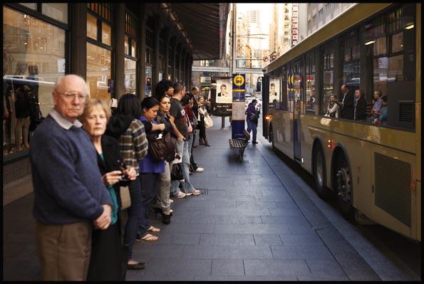 people queuing to get on a bus