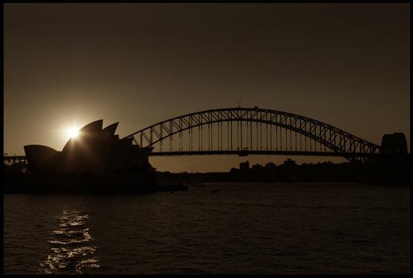 sunset behind the Opera House and Harbour Bridge